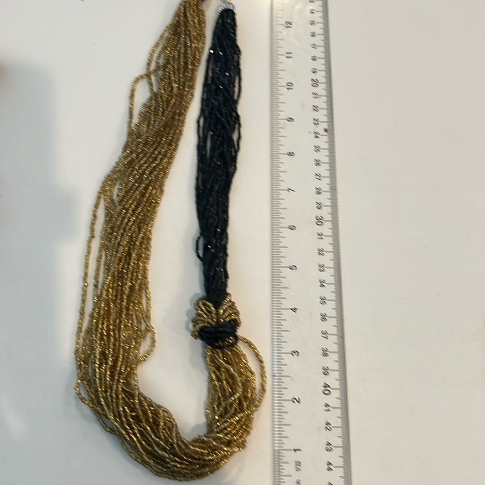 Gold and black necklace arranged in a unique way from Murano glass beads